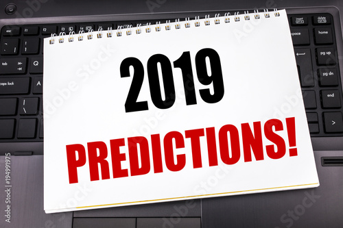 Handwritten text showing 2019 Predictions. Business concept writing for Forecast Predictive written on notepad note paper on the black keyboard background.