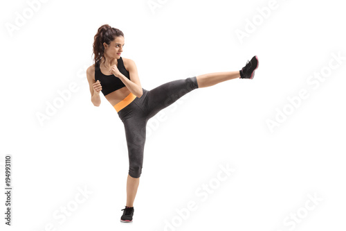 Fitness woman kicking