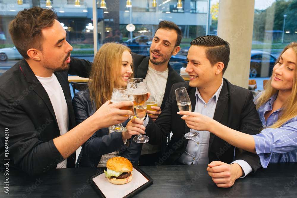 Friends clinking glasses in pub Friends clinking glasses in pub