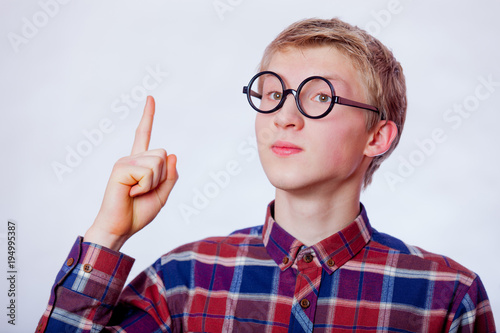 Young nerd teen boy with round glasses