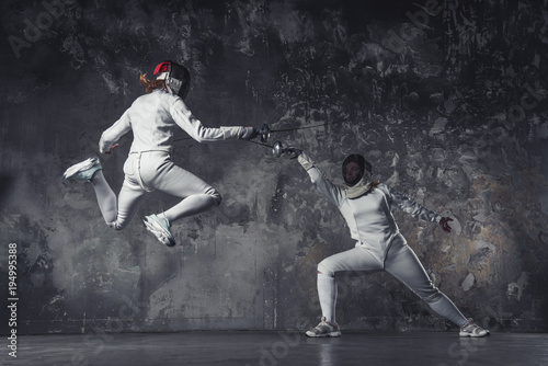 Two women fencing photo