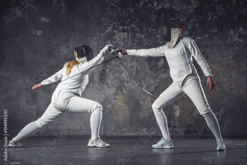 Two women fencing