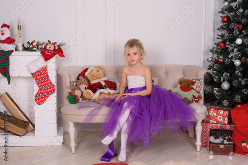 little child girl dreams of becoming ballerina in a purple tutu skirt