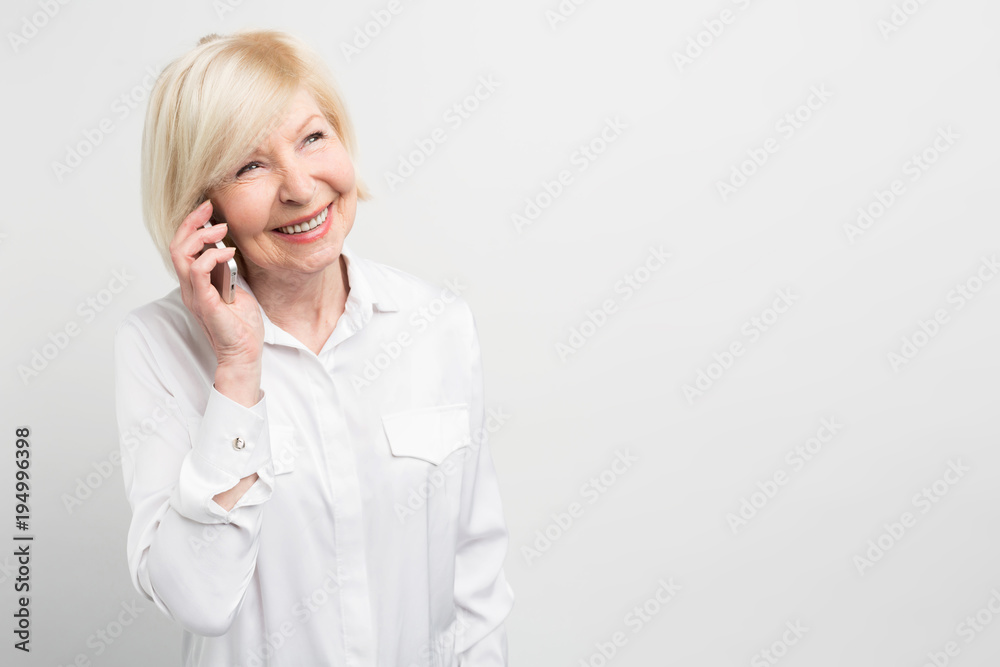 Nice picture of a lady calling t his family using a new smartphone. She adores new technologies and like to try to use new devices as much as she can. Isolated on white background. Nice picture of a lady calling t his family using a new smartphone. She adores new technologies and like to try to use new devices as much as she can. Isolated on white background.
