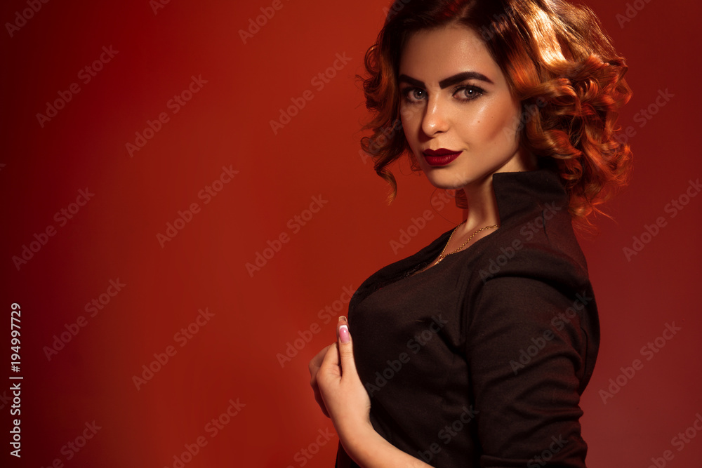 Gorgeous young lady with red lips and beautiful hairstyle