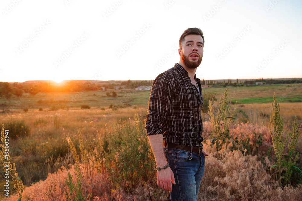 Handsome man on sunset background