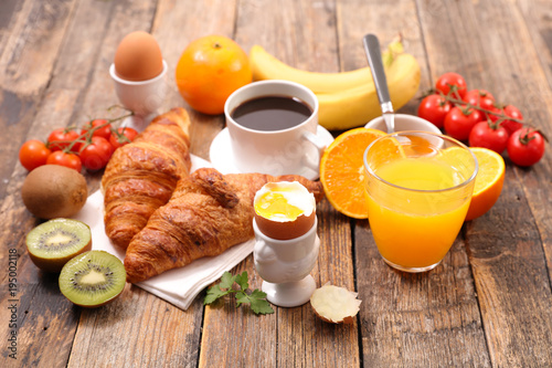 healthy breakfast with coffee  croissant and boiled egg
