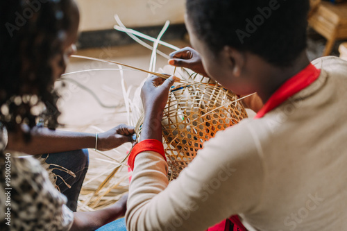 Obraz na plátně Woman weaving basked out of bamboo in Rwanda Africa