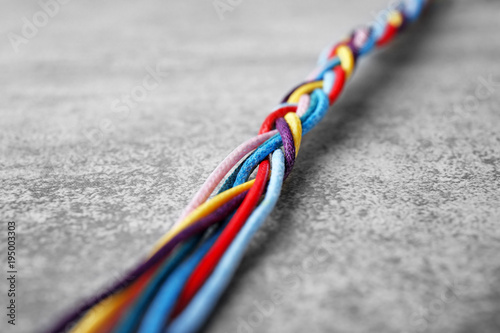 Braided strings on light background. Unity concept photo