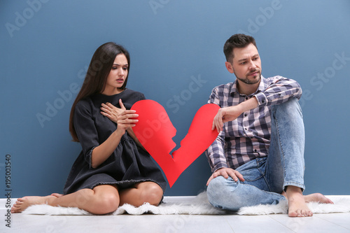 Young couple tearing paper ...