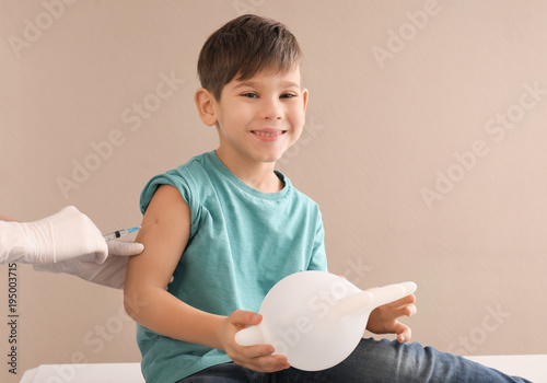 Doctor vaccinating little c...
