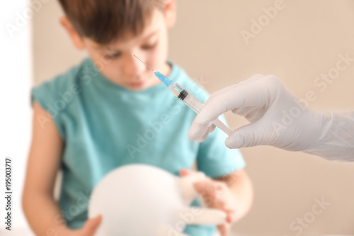 Doctor preparing syringe fo...
