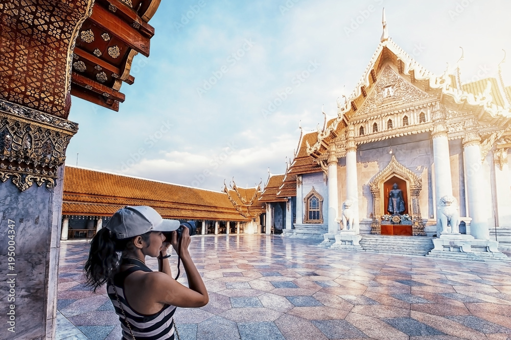 Tourist girl take photography of the Marble temple in Bangkok