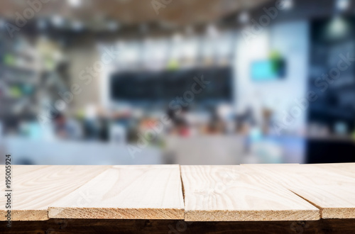 Selected focus empty brown wooden table and Coffee shop or restaurant blur background with bokeh image. for your photomontage or product display. © snowing12