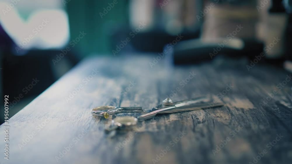 Woman is putting hairdresser's scisors on table in hair salon. Closeup view Woman is putting hairdresser's scisors on table in hair salon. Closeup view