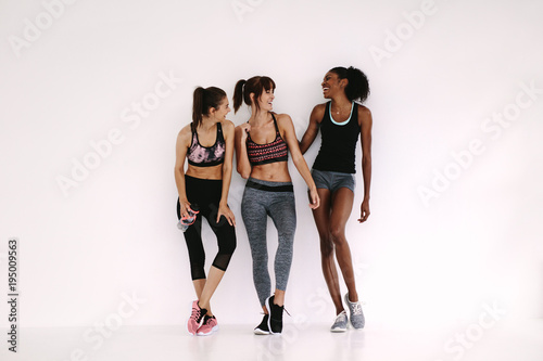 Group of sporty girls talking in fitness studio