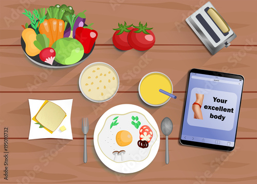 Breakfast (lunch or dinner) fromeggs, juice, a sandwich with cheese, fruit and vegetables - foods for diet and healthy eating. With tablet with text healthy eating.