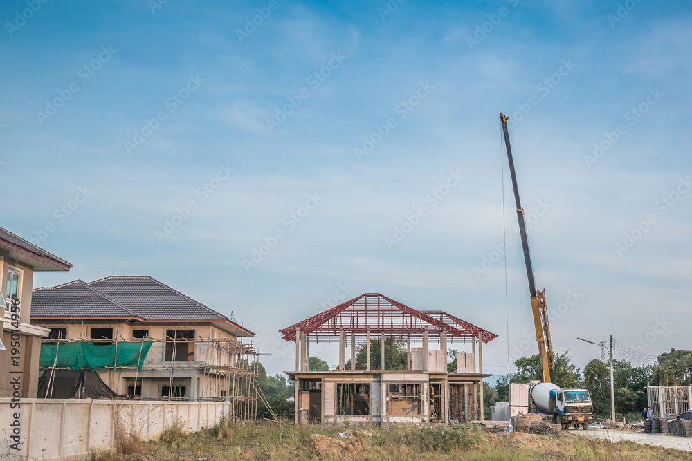 House building at construction site with crane truck