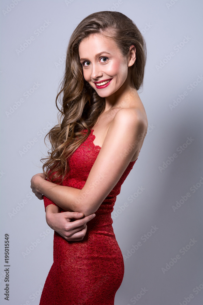 Portrait of a smiling young woman in a red dress Portrait of a smiling young woman in a red dress