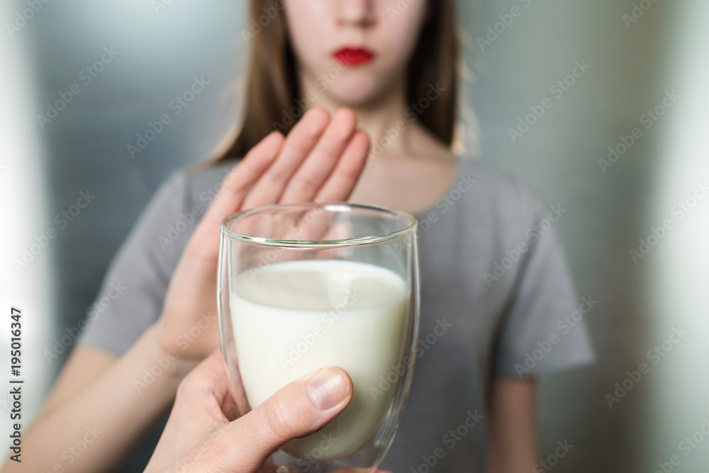 Lactose intolerance. Dairy Intolerant young girl refuses to drink milk Lactose intolerance. Dairy Intolerant young girl refuses to drink milk