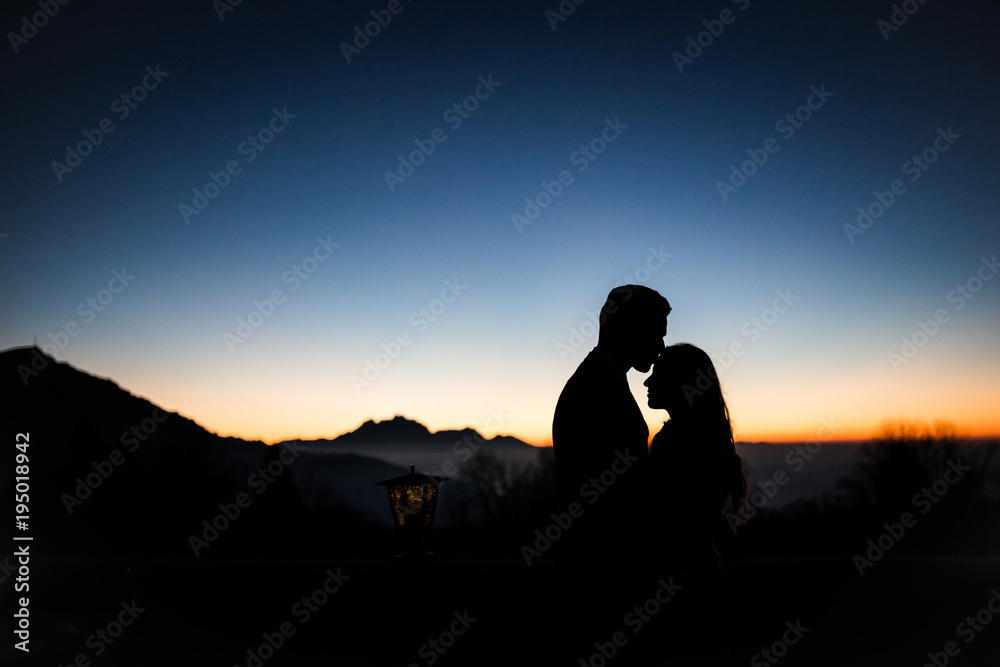 Couple in love silhouette in front of mountains