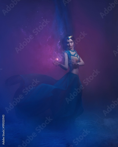 A girl in oriental attire, Queen of the storm. Princess Jasmine. The background is a twist and a strong wind. Studio shooting with mixed light. Artistic Photography © kharchenkoirina