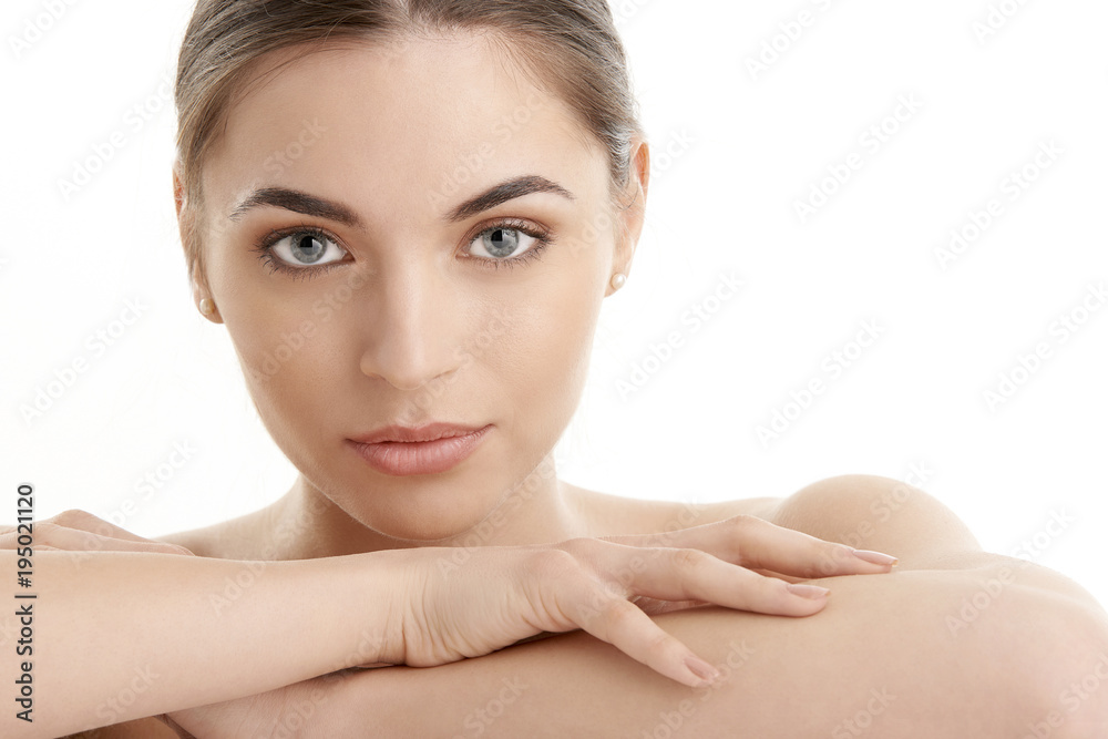 Fototapeta premium Beautiful young woman with perfect skin. Beauty shot on white background
