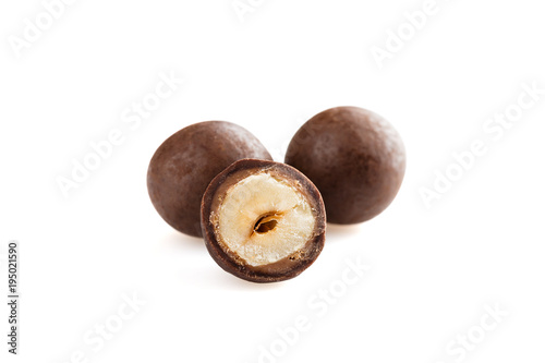 Heap of sugared hazelnuts dragees in chocolate isolated on white background