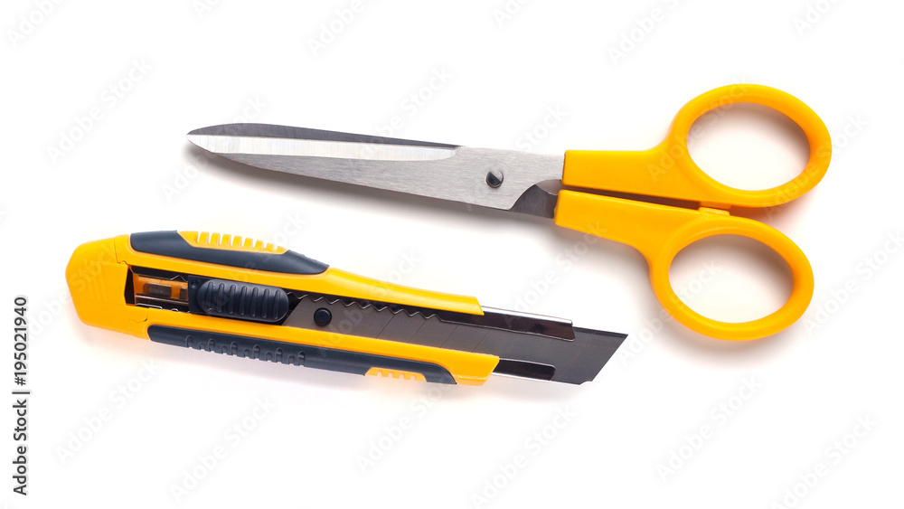 Yellow scissors and cutter knife isolated on white background Yellow scissors and cutter knife isolated on white background