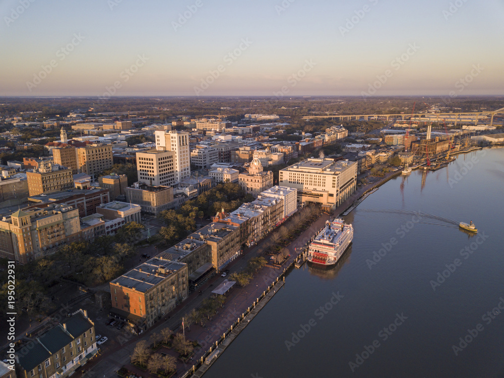 Fototapeta premium Aerial view of downtown Savannah, Georgia, River Street, and ferry boat.