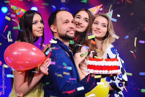 a guy and three girls rejoice and celebrate the party in the night club