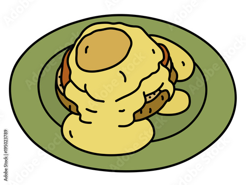 The cooked eggs Benedict with a hollandaise sauce on the green saucer