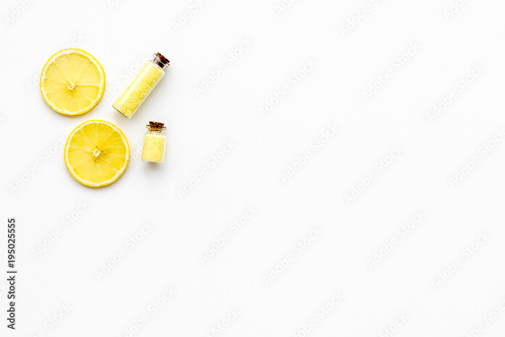 Aromatic yellow spa salt with lemon scent on white background top view copy space Aromatic yellow spa salt with lemon scent on white background top view copy space