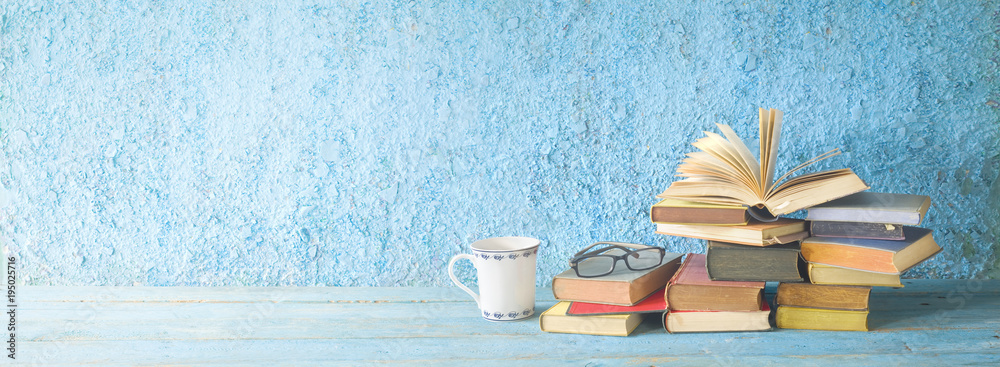 Pile of old books, open book, glasses and a cup of coffee. Reading,  literature,education concept. Panoramic with free copy space Stock Photo |  Adobe Stock
