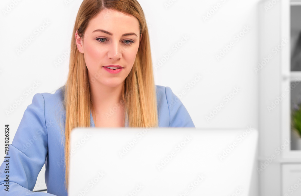 Business attractive woman working on laptop at workplace or at home. Business attractive woman working on laptop at workplace or at home.