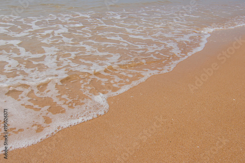 Soft wave of the blue ocean on the seashore of Thailand, copy space on the sand copy space