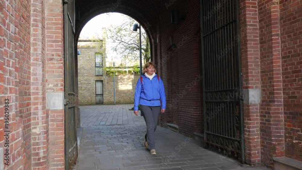 Woman Tourist Walks Through The Arch Of House Woman Tourist Walks Through The Arch Of House