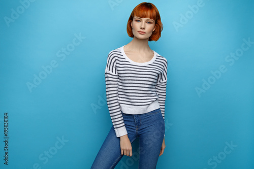 Beautiful woman with red hair isolated on blue background