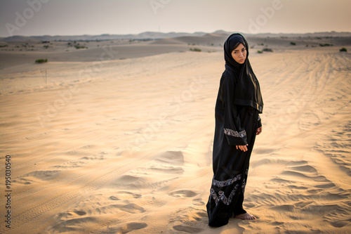 Arab woman standing in the desert.
