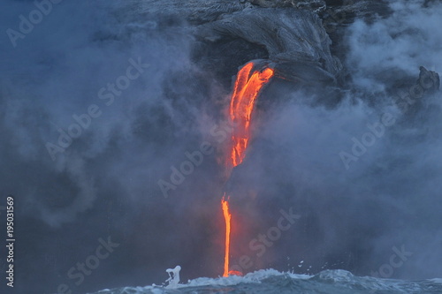 Molten volcanic lava flows into the waters of the Pacific Ocean