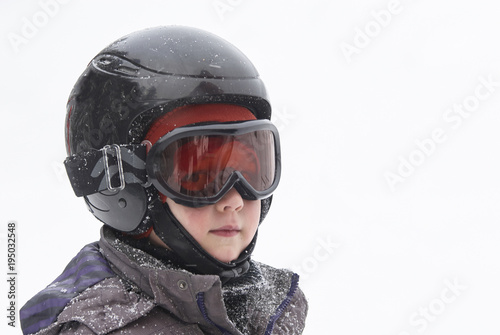 Child boy skiing in mountains. Active teenager kid with safety helmet and goggles. Ski race for young children. Winter sport for family. Young skier racing in snow   © Petr Bonek