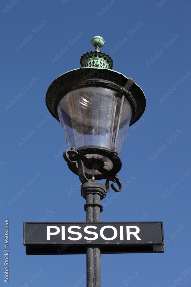 Street light with pissoir sign in Copenhagen, Denmark Street light with pissoir sign in Copenhagen, Denmark