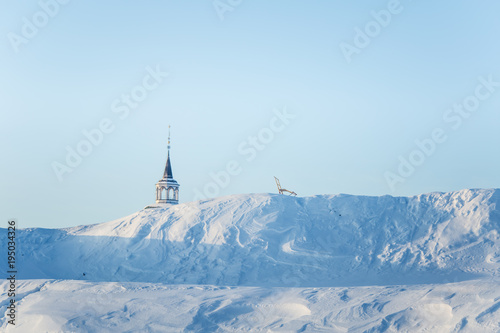 A beautiful tower of Roros church in central Norway. World heritage site. Winter town landscape. © dachux21
