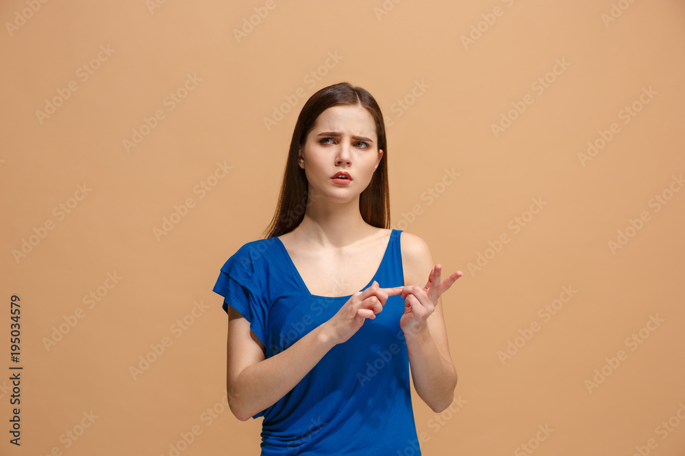 Let me think. Doubtful pensive woman with thoughtful expression making choice against pastel background Let me think. Doubtful pensive woman with thoughtful expression making choice against pastel background