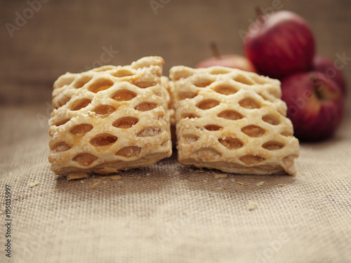 Apple lattices on a hessian surface, red apples out of focus in the background. 