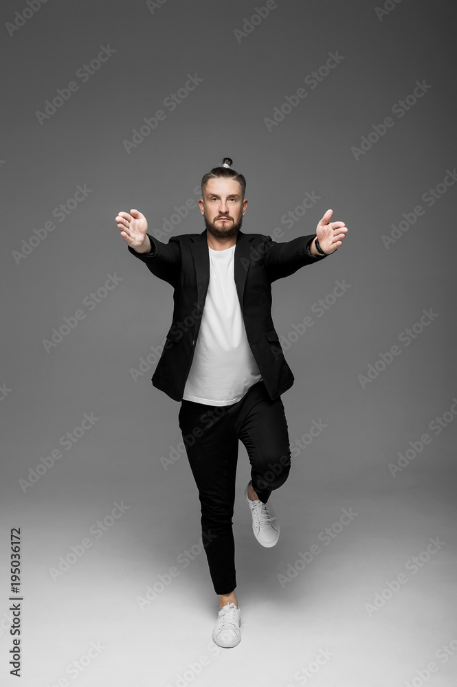 emotional man in a shirt with black hearts on a gray background
