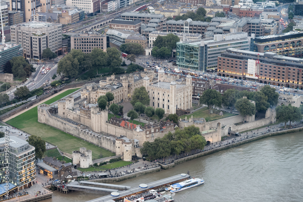 LONDON - SEPTEMBER 24, 2016: Aerial view of Tower of London and city skyline at night. The city attracts 30 million tourists annually