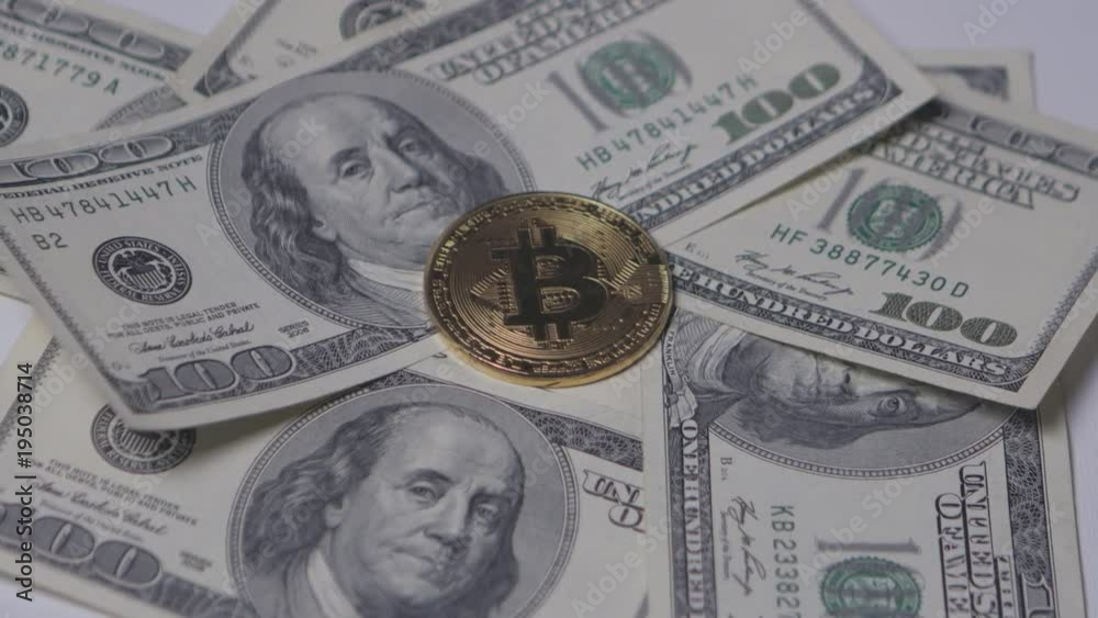 Gold Bit Coin BTC coins with bills of 100 dollars rotating on white background Gold Bit Coin BTC coins with bills of 100 dollars rotating on white background