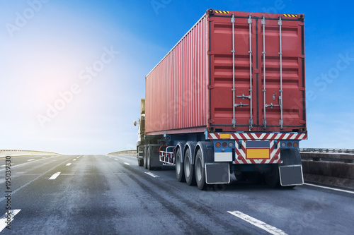 Truck on highway road with red container, transportation concept.,import,export logistic industrial Transporting Land transport on the asphalt expressway with blue sky