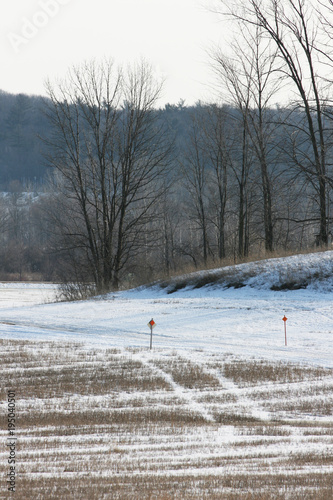 Winter Snowmobile Trail across farmland in the midwest. Vertical